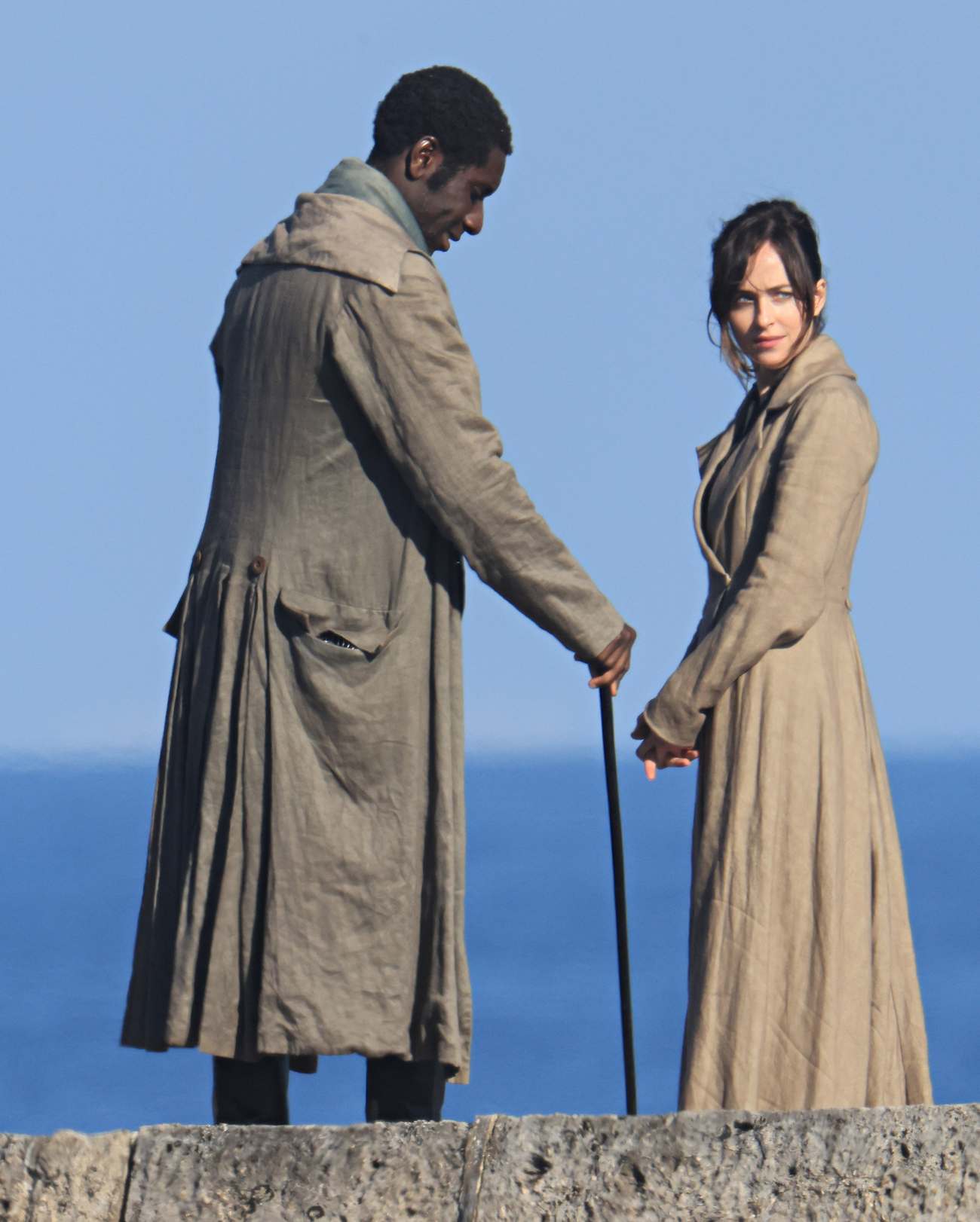 Dakota_Johnson_-_filming__Persuasion__on_The_Cobb_at_Lyme_Regis2C_UK_06152021_01.jpg